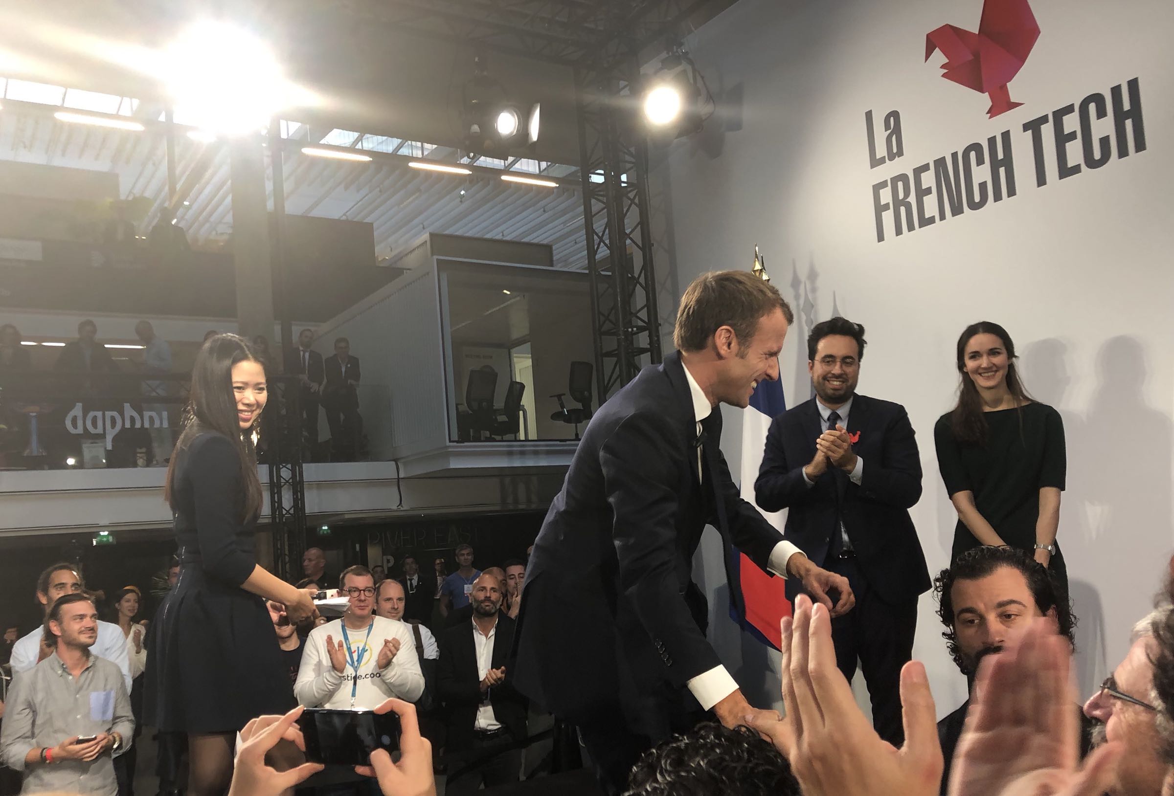 President Macron connecting with the audience by shaking hands after Q&A
