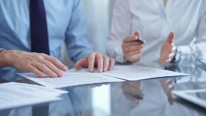Corporate meeting, zoom on hands and documents
