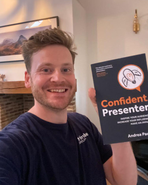 Reader 2 selfie holding Confident Presenter book in front of him